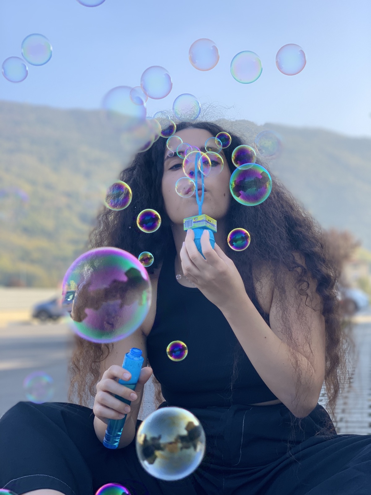 Anna blowing bubbles outdoors
